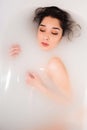 Attractive girl takes a bath with milk. Spa treatments Royalty Free Stock Photo