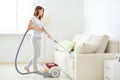 Attractive girl with vacuum cleaner Royalty Free Stock Photo
