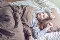 Woman waking up in the morning, lying sleepy in bed