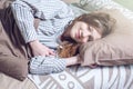 Woman waking up in the morning, lying sleepy in bed