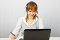 Attractive girl in a white blouse with a laptop Royalty Free Stock Photo