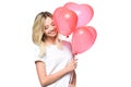 attractive girl in white shirt holding bundle of heart shaped balloons