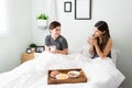 Attractive girlfriends eating breakfast in bed during the morning Royalty Free Stock Photo