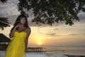 Attractive and glamorous African American black woman in chic and elegant summer dress posing relaxed