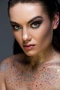 attractive glamorous model posing with glitter on body