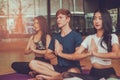 Attractive group of young multi-ethnic diversity,exercise and yoga with meditation lesson classes in studio,with concept of