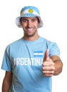 Attractive guy with argentinian jersey and hat showing thumb up Royalty Free Stock Photo