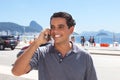 Attractive guy at Rio de Janeiro speaking at phone Royalty Free Stock Photo