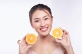 Attractive half-naked asian woman amiling while holding orange slices near her face Royalty Free Stock Photo