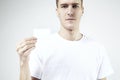 Attractive handsome businessman holding, showing empty business card, space for layout, with white background