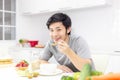 Attractive handsome man eat breakfast or cereal, fruits, milk on