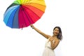 Attractive and happy Asian woman holding rainbow colorful umbrella or parasol  smiling playful isolated on white background in Royalty Free Stock Photo