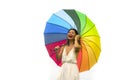 Attractive and happy Asian woman holding rainbow colorful umbrella or parasol  smiling playful isolated on white background in Royalty Free Stock Photo