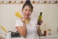 Attractive and happy Asian woman preparing noodles - domestic lifestyle portrait of young sweet and playful Korean girl at home Royalty Free Stock Photo