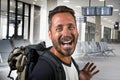 Attractive and happy backpacker man 30s or 40s carrying backpack going for holidays travel in tourism and exploring concept at Royalty Free Stock Photo