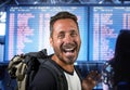 Attractive and happy backpacker man 30s or 40s carrying backpack going for holidays travel in tourism and exploring concept at Royalty Free Stock Photo