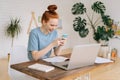 Attractive happy cheerful redhead young businesswoman using mobile phone. Royalty Free Stock Photo