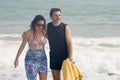 Attractive and happy couple enjoying beautiful holidays walking cheerful and relaxed on the beach along the sea smiling playful in Royalty Free Stock Photo