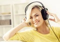 Attractive happy girl listening music at home. Royalty Free Stock Photo