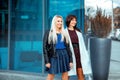 Attractive happy ladies brunette and blonde looking away Royalty Free Stock Photo