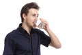 Attractive happy man drinking water from a glass