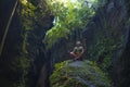 Attractive and happy mid adult woman with grey hair 40s or 50s enjoying blissful and free sitting in lotus yoga pose at beautiful Royalty Free Stock Photo