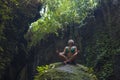 Attractive and happy mid adult woman with grey hair 40s or 50s enjoying blissful and free sitting in lotus yoga pose at beautiful Royalty Free Stock Photo