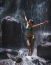 Attractive and happy mid adult woman with grey hair 40s or 50s enjoying blissful and free at beautiful tropical waterfall feeling Royalty Free Stock Photo