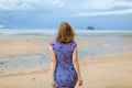 Attractive and happy middle aged woman walking along the seashore on misty day. Mature female joyful expression Royalty Free Stock Photo