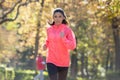 Attractive and happy runner woman in Autumn sportswear running a Royalty Free Stock Photo