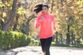 Attractive and happy runner woman in Autumn sportswear running a Royalty Free Stock Photo