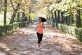Attractive and happy runner woman in Autumn sportswear running a Royalty Free Stock Photo