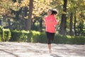 Attractive and happy runner woman in Autumn sportswear running a Royalty Free Stock Photo