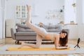 Happy lady with prosthesis arm does yoga exercises at home