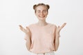 Attractive happy and stylish european woman in trendy glasses and pink t-shirt, raising palms and gesturing joyfully