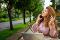 Attractive happy stylish plus size African American Black business woman speaks phone working online on laptop computer Royalty Free Stock Photo