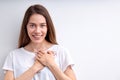 Attractive happy woman expressing gratitude, holding hands on chest, thankful