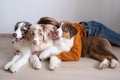 Woman holding three beatiful Small merle Australian shepherd puppy dog Royalty Free Stock Photo