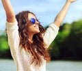 Attractive happy woman in sunglasses enjoying freedom outdoors w Royalty Free Stock Photo