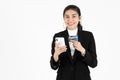 Attractive happy young Asian business woman holding mobile smart phone over white isolated background. Social network, Internet Of Royalty Free Stock Photo