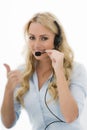 Attractive Happy Young Business Woman Using a Telephone Headset Royalty Free Stock Photo