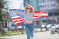 Attractive happy young girl with the flag of the United states of America Royalty Free Stock Photo