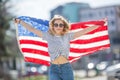 Attractive happy young girl with the flag of the United states of America Royalty Free Stock Photo
