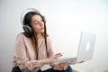 Attractive happy young girl student studying at the college library, sitting at the desk, using laptop computer, having Royalty Free Stock Photo