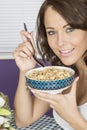 Attractive Happy Young Woman Eating Breakfast Cereal Royalty Free Stock Photo