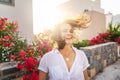 Attractive happy young woman in white shirt flying hair enjoying sunset outdoor. Beauty curly girl portrait at summer. Freedom Royalty Free Stock Photo