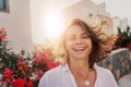 Attractive happy young woman in white t shirt flying hair enjoying her free time at sunset outdoor, portrait at summer. Freedom Royalty Free Stock Photo