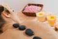 Attractive healthy caucasian woman hot stone massage wellness