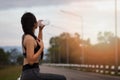 Attractive healthy fitness girl drinking water after workout. Runner girl take a rest after training Royalty Free Stock Photo