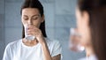 Attractive healthy young woman drink fresh mineral water in morning Royalty Free Stock Photo